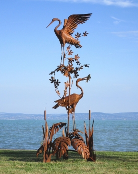 Heron pair on tree garden sculpture rusty