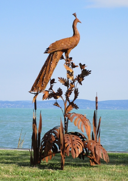 Peacock on tree rusty garden sculpture