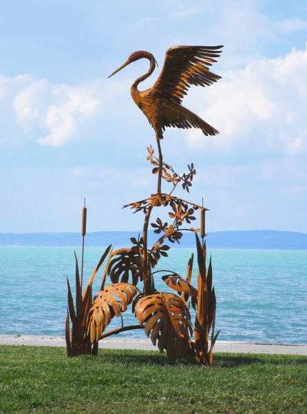 Heron on tree garden sculpture rusty